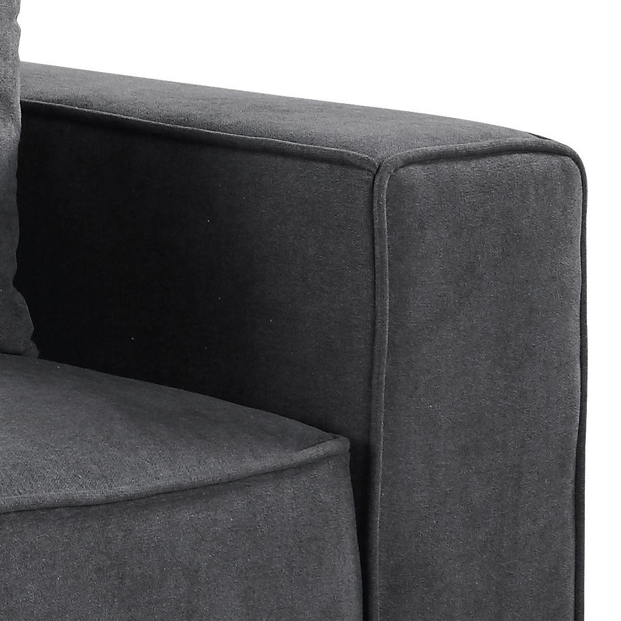 Closeup of dark grey upholstered sofa armrest with stitched detailing