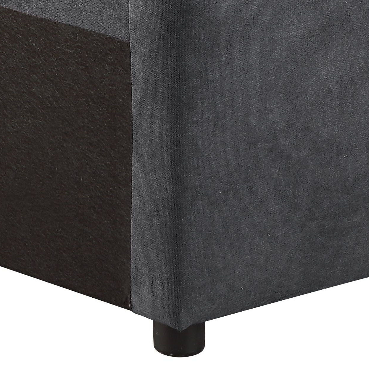 Dark gray velvet upholstered sofa armrest with brown textured fabric side