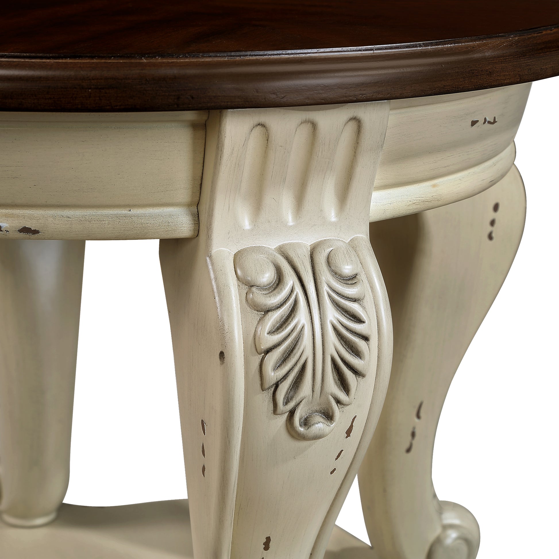 Distressed cream carved pedestal base on a round antique dining table