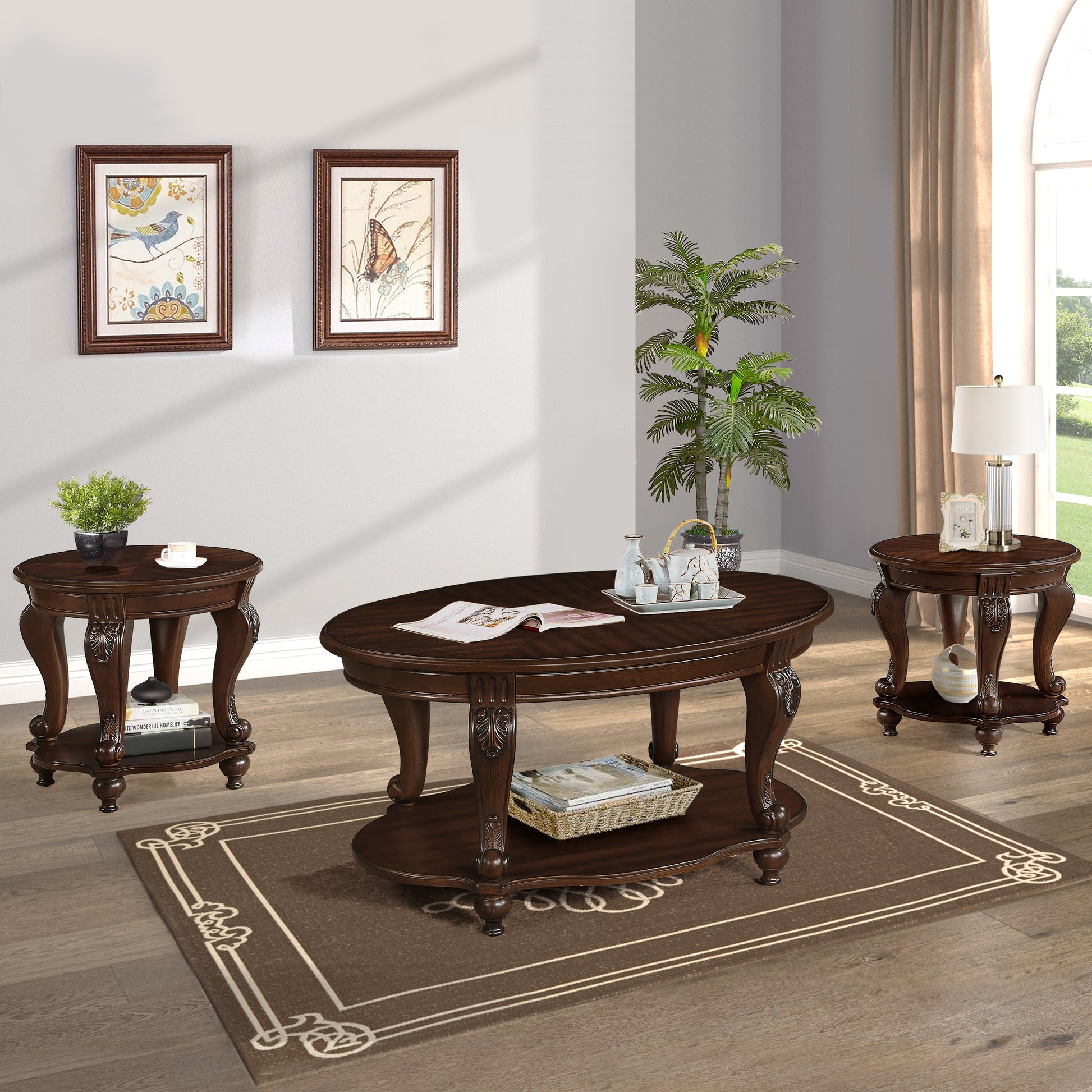 Dark cherry oval coffee table with decorative legs and a lower shelf holding magazines