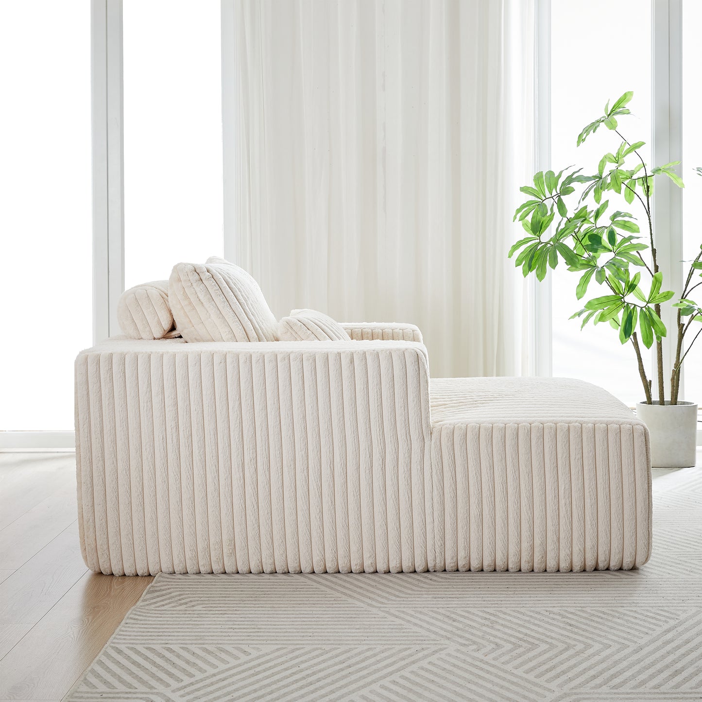 Plush cream boucle sofa with ribbed texture and scatter cushions perfect for modern living rooms