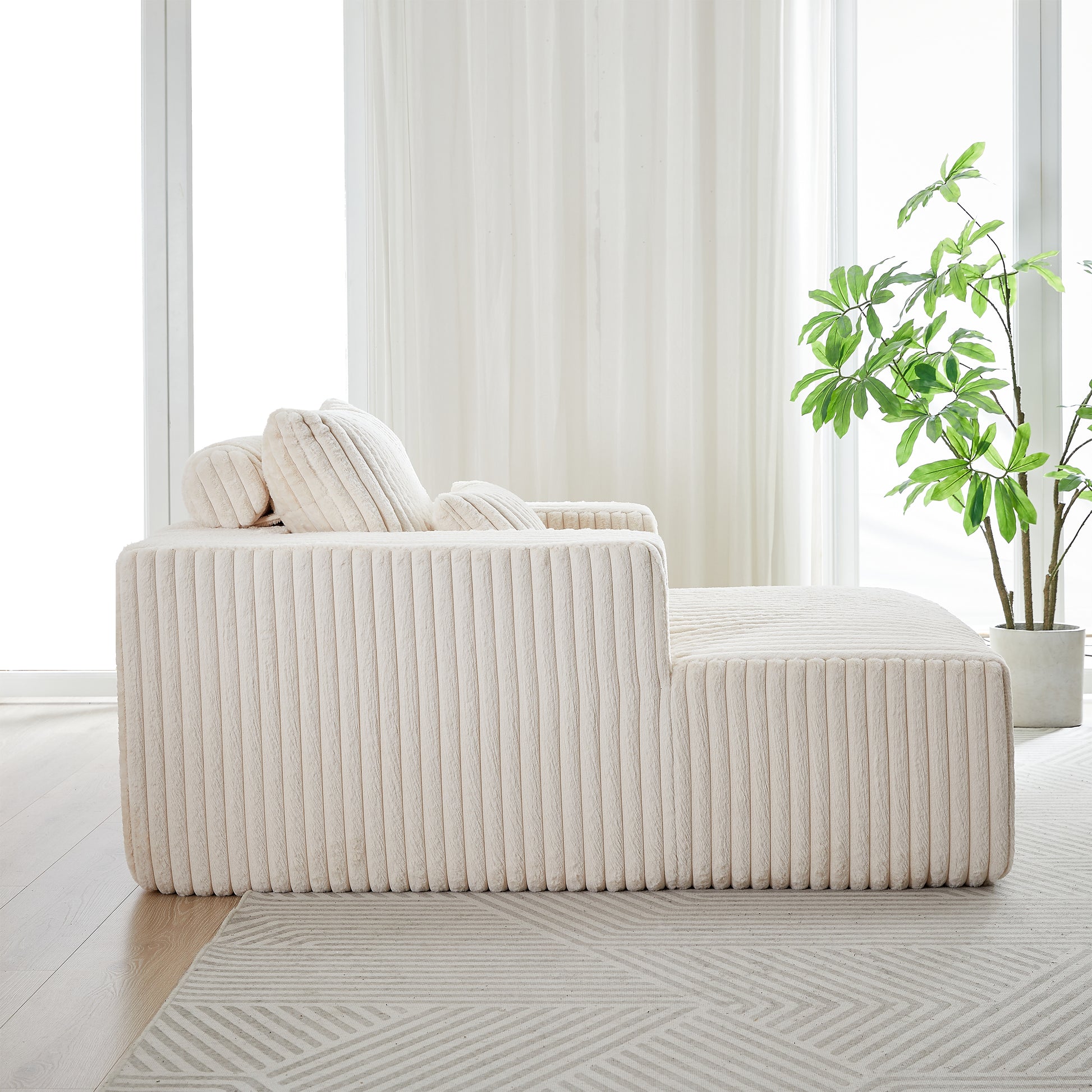 Plush cream boucle sofa with ribbed texture and scatter cushions perfect for modern living rooms