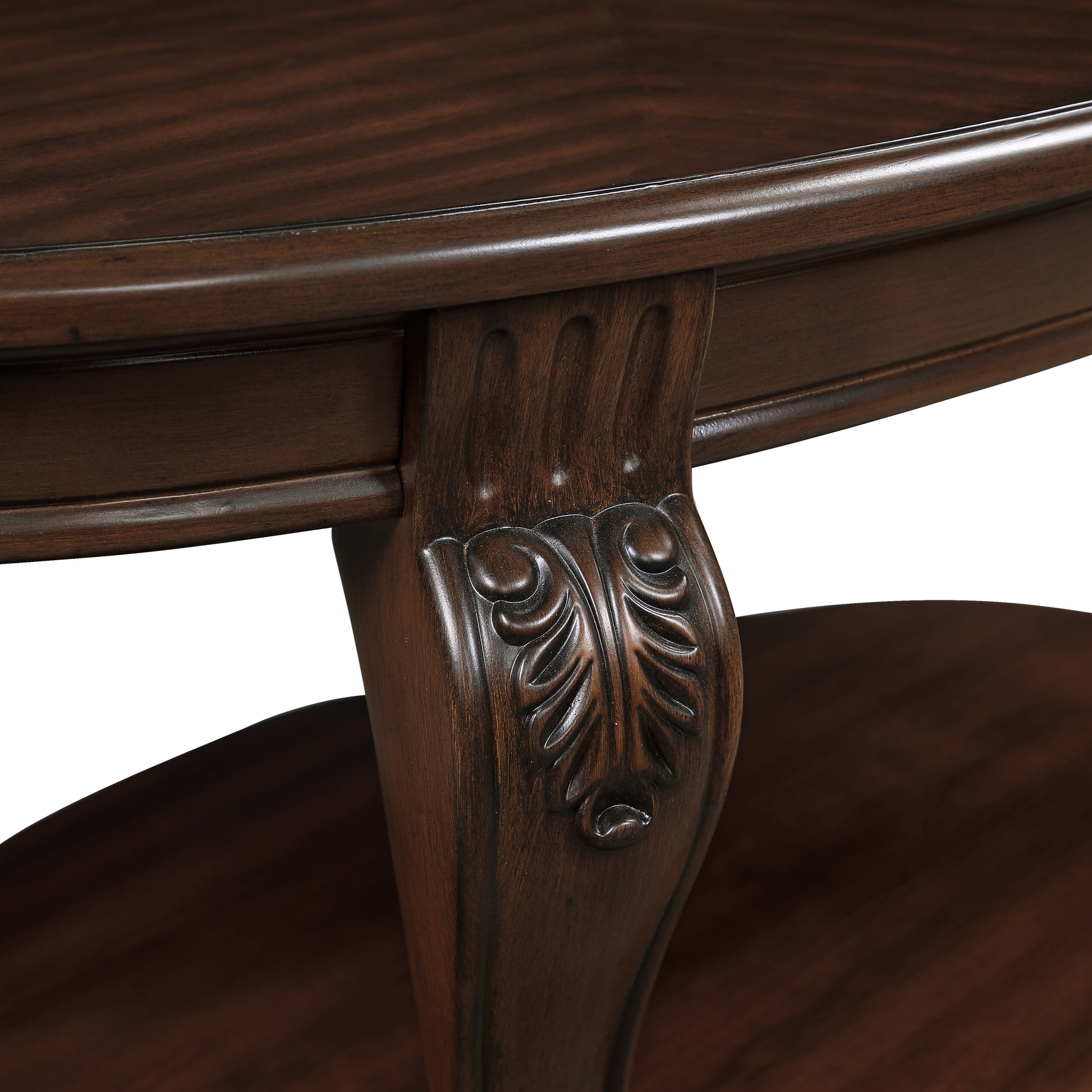 Dark brown wooden oval coffee table with carved leg detail and stretcher