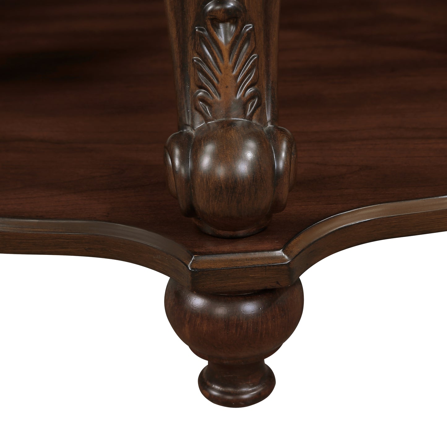 Closeup of ornate dark wood carved leg detail on antique furniture