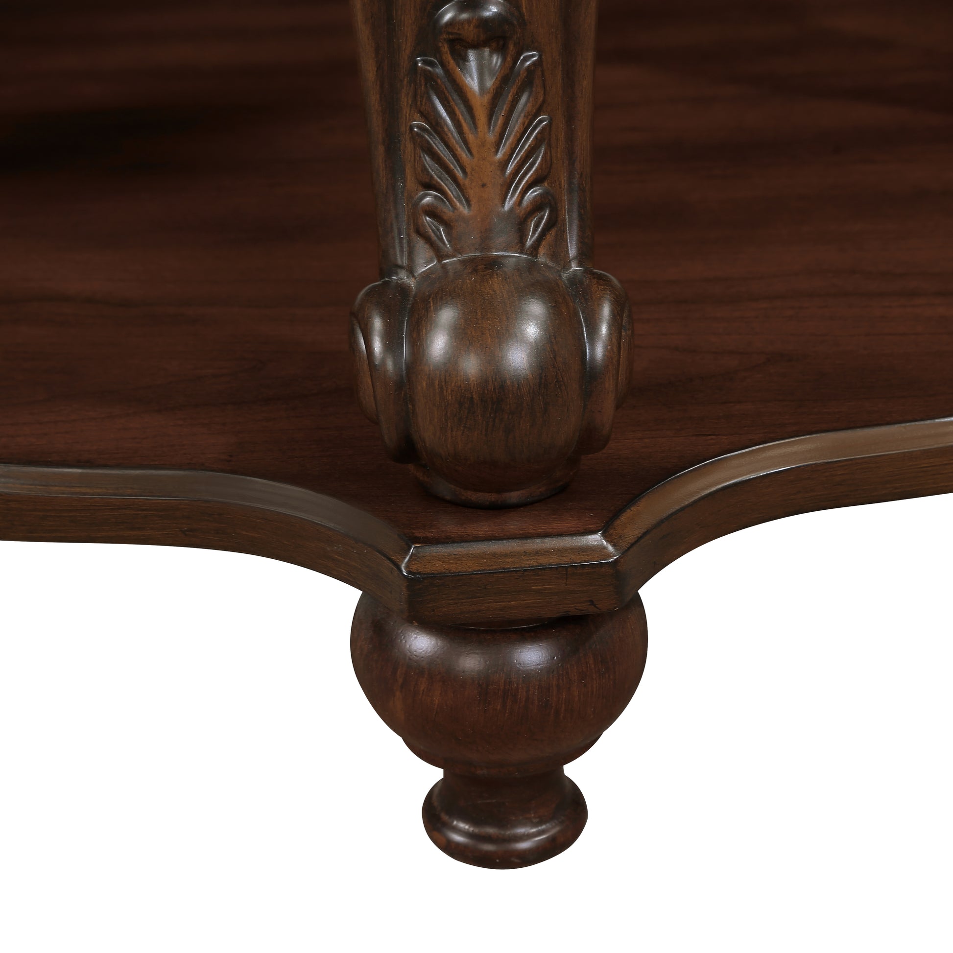 Closeup of ornate dark wood carved leg detail on antique furniture