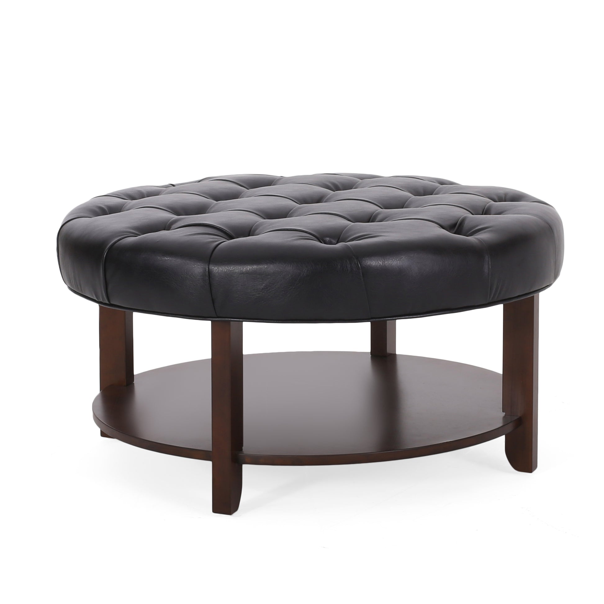 Round tufted black leather ottoman with wooden legs and lower shelf