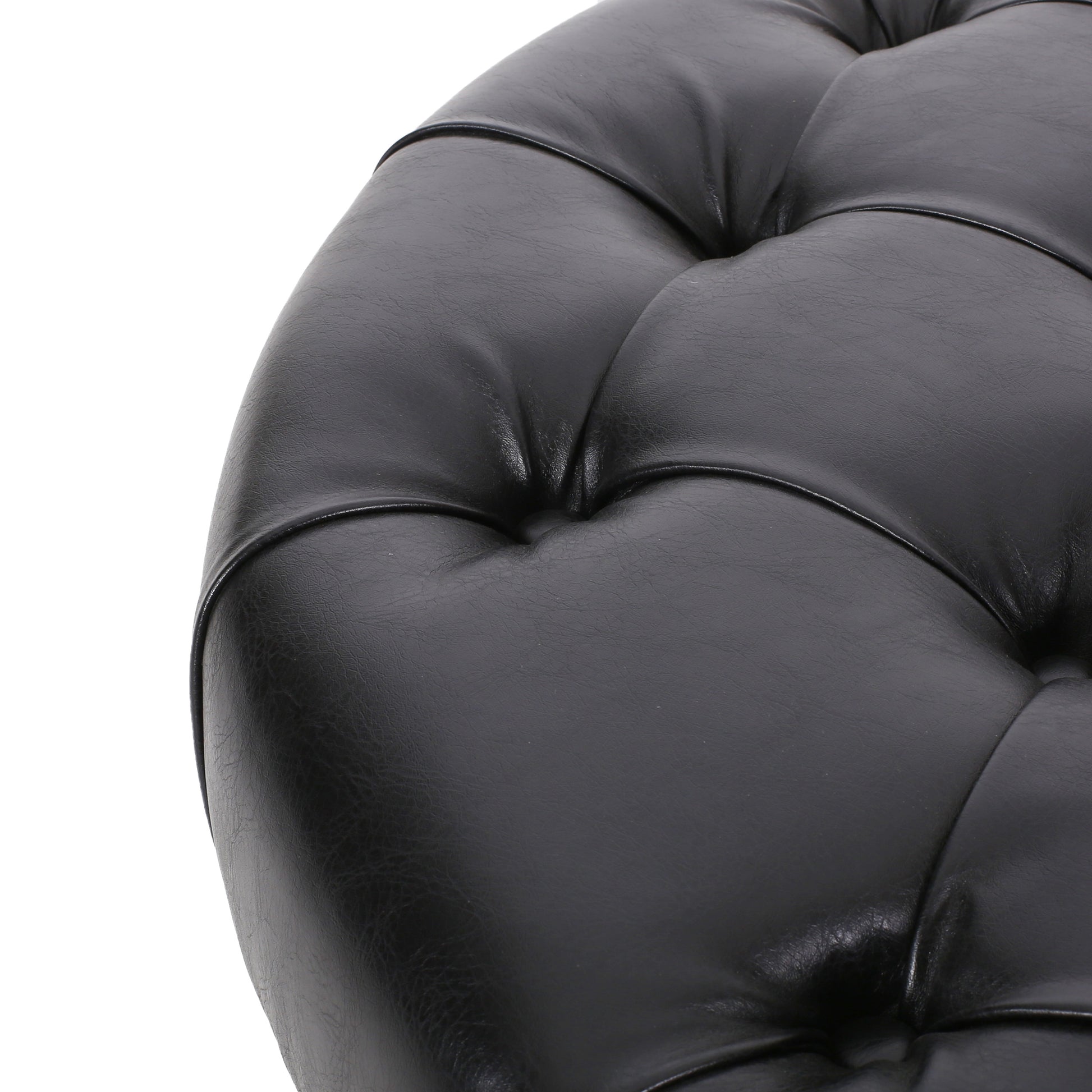 Black leather tufted ottoman detail