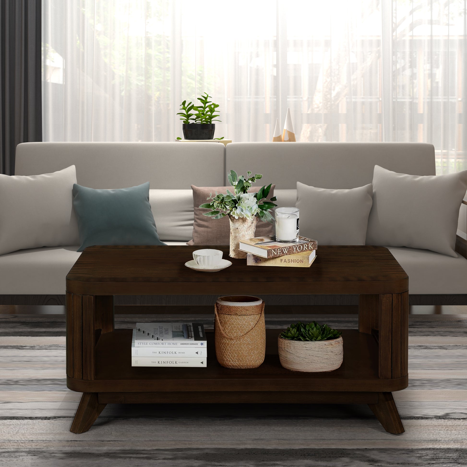 Dark wood coffee table with slatted sides featuring books and a candle