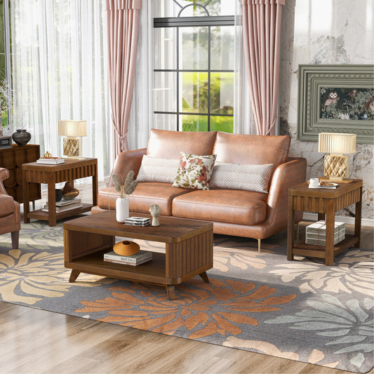 Tan leather sofa with textured pillows and a modern coffee table