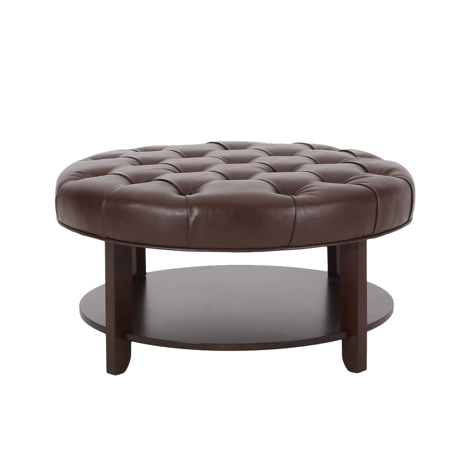 Tufted brown faux leather round ottoman with dark wood legs and lower shelf