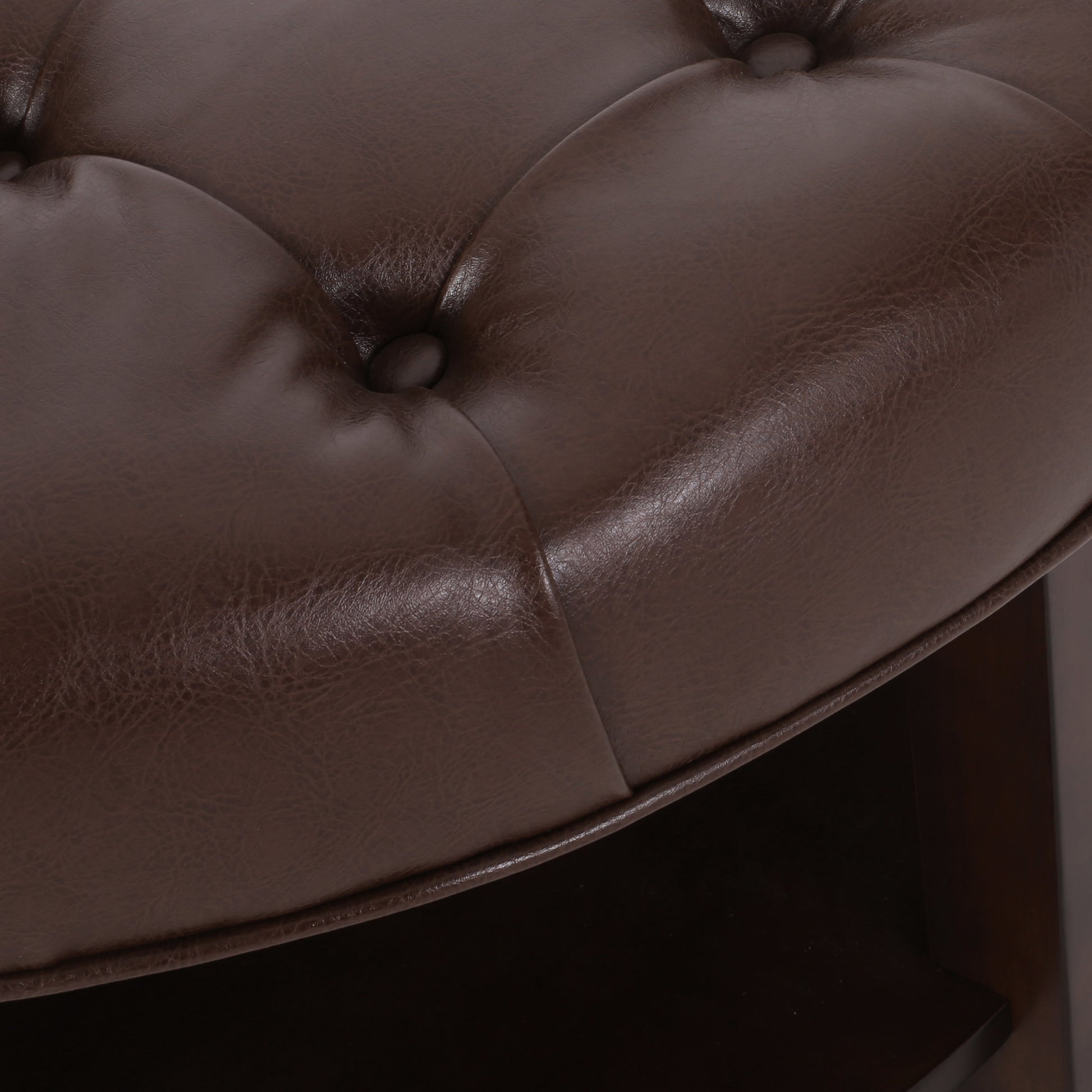 Tufted dark brown faux leather ottoman detail