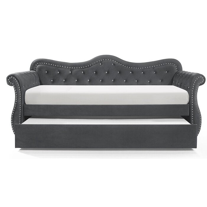 Dark gray velvet daybed with tufted back and rhinestone accents featuring a pullout trundle