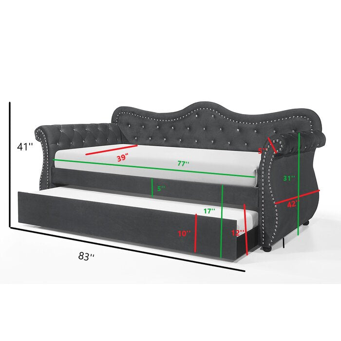 Dark gray velvet daybed with tufted back and studded accents featuring pullout trundle bed