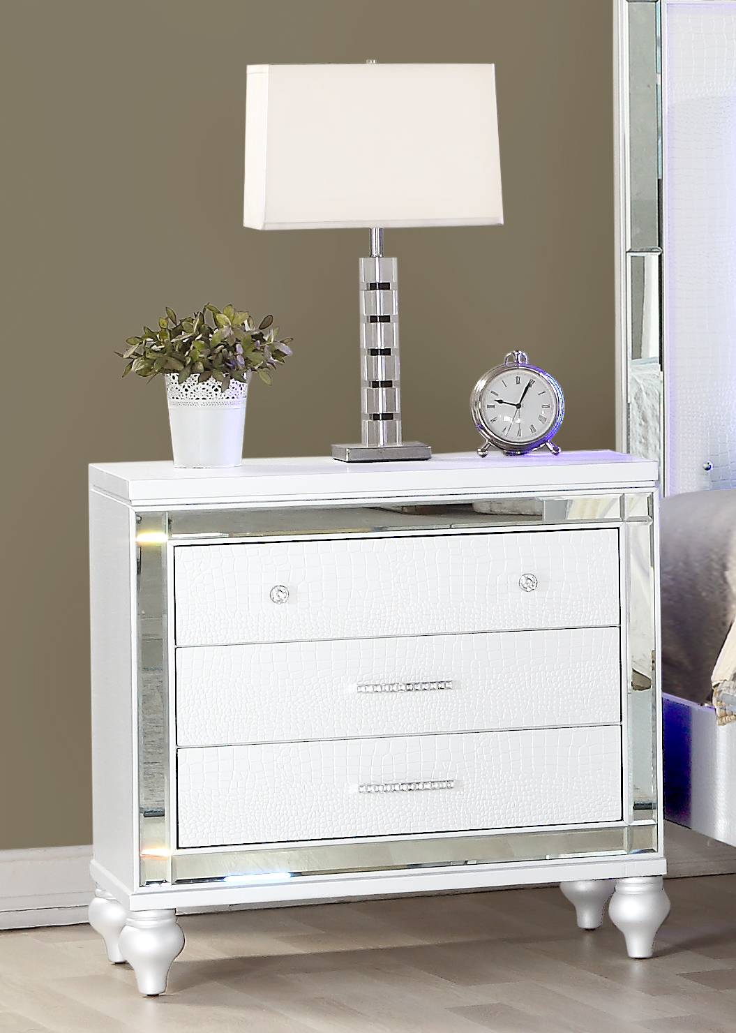 White threedrawer nightstand with crocodile texture drawer fronts and mirrored trim