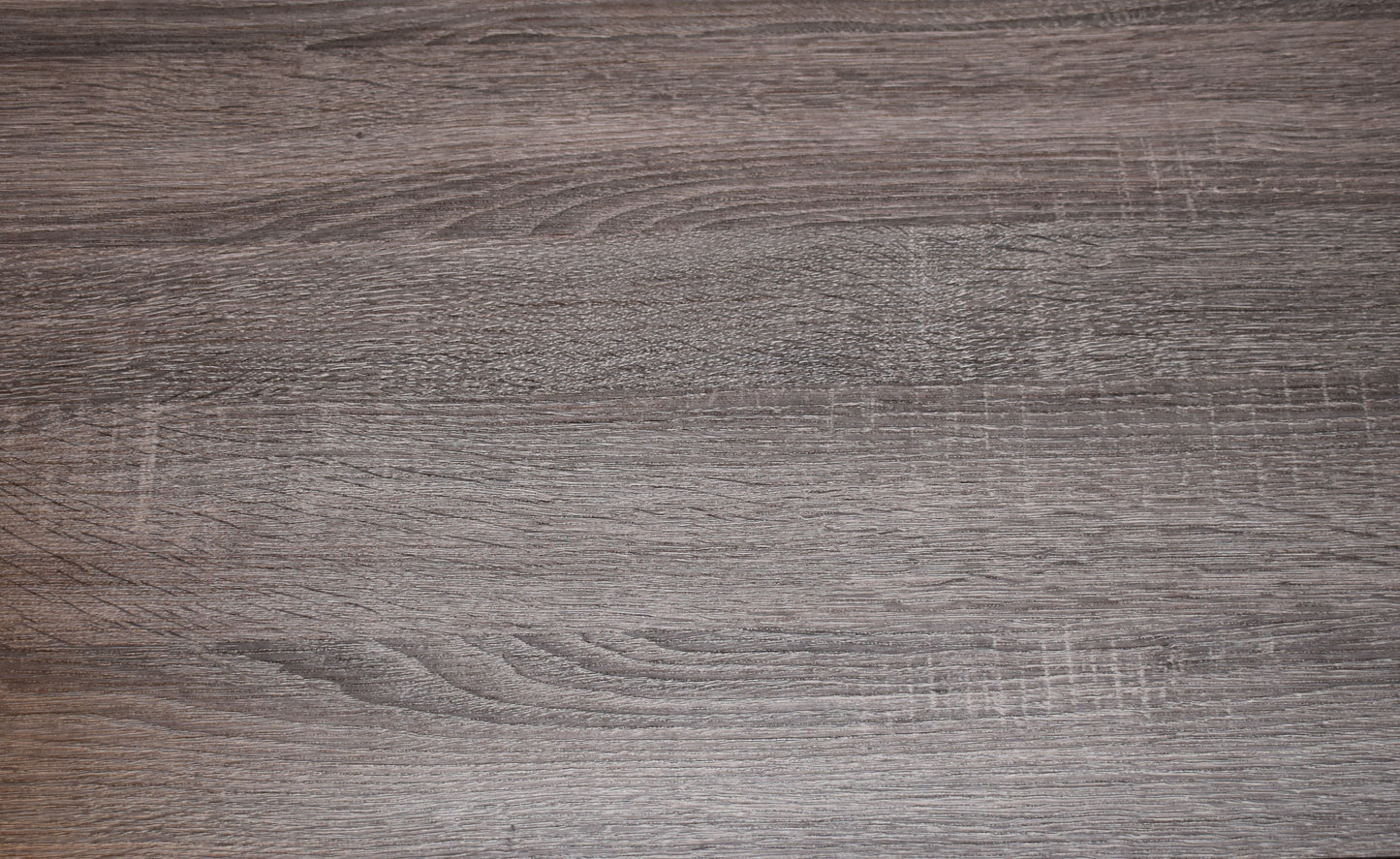 Dark gray wood grain laminate surface with prominent horizontal lines and subtle texture
