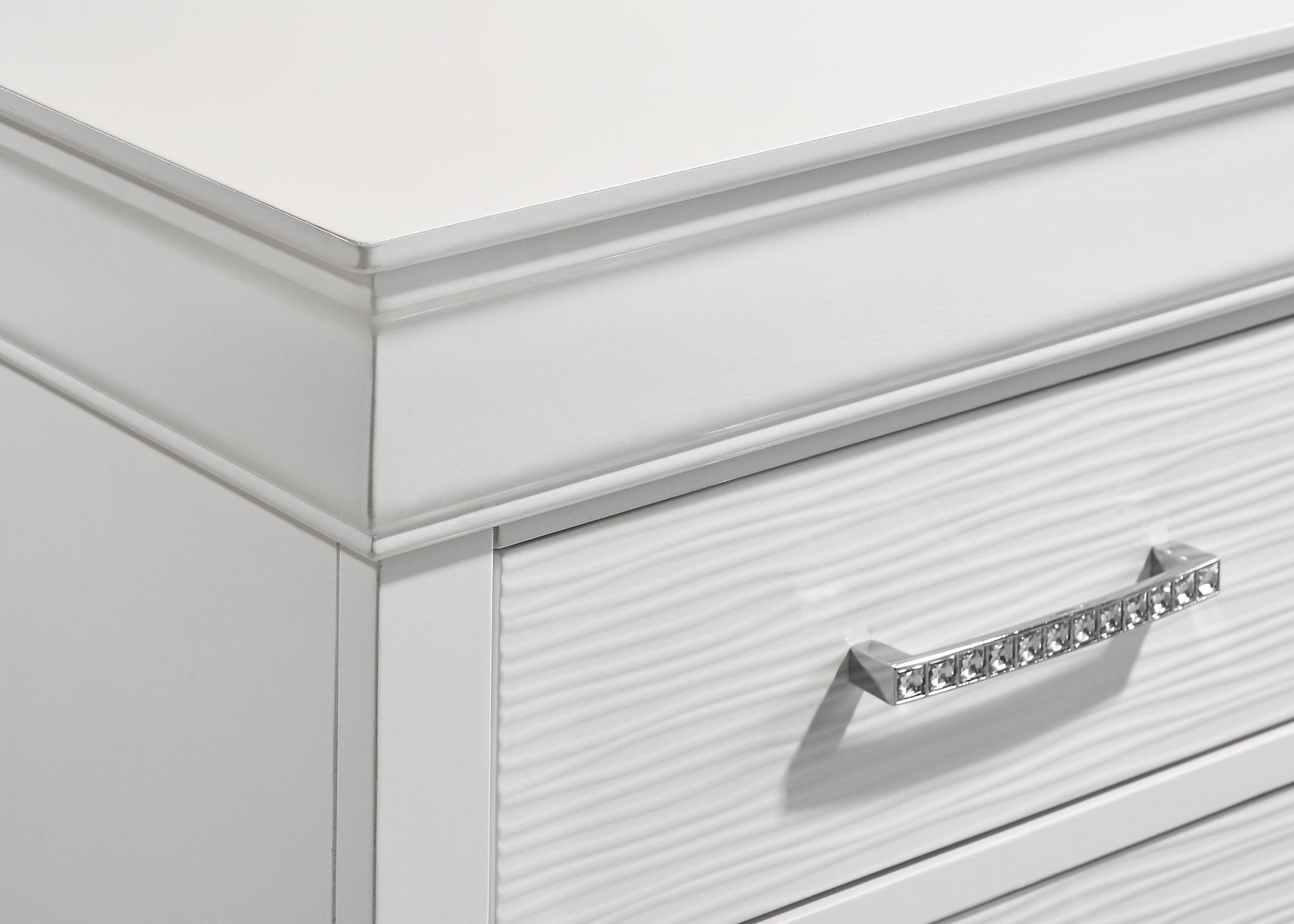 White dresser drawer front with textured surface and crystal knob