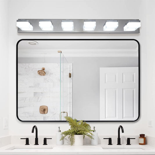 Modern chrome vanity light bar with four frosted glass cube shades illuminates bathroom