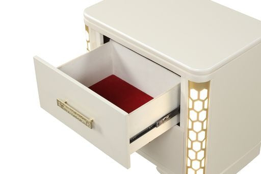 Cream nightstand with an open drawer featuring a gold honeycomb design accent