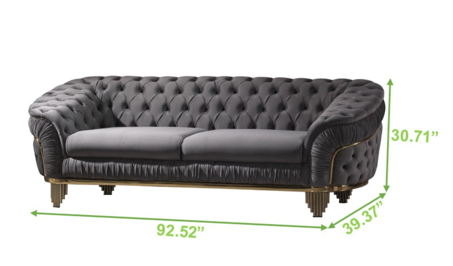 Grey velvet tufted chesterfield sofa with gold accents and ornate legs