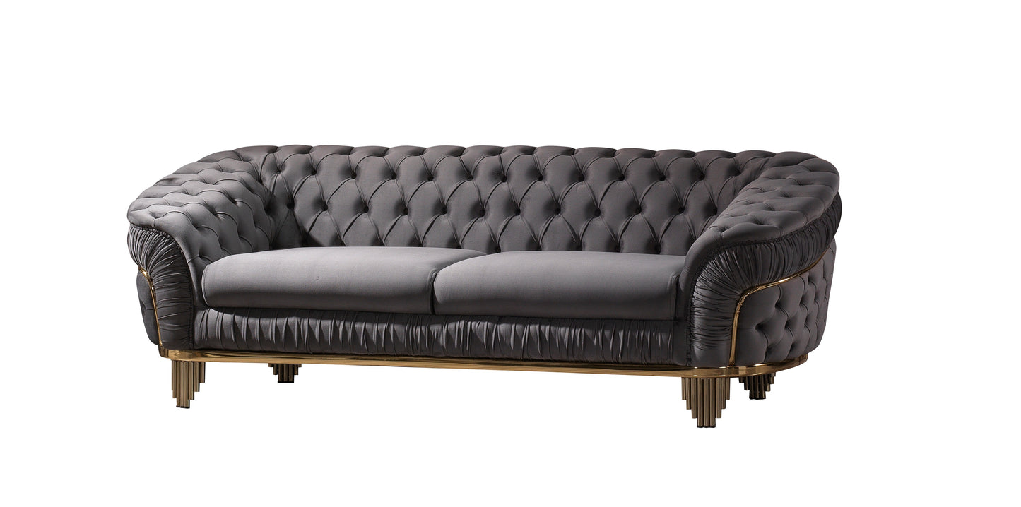 Dark grey tufted velvet sofa with elegant gold trim and modern fluted legs