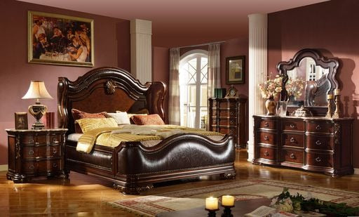 Ornate dark wood sleigh bed with leather headboard and plush pillows perfect for a master bedroom