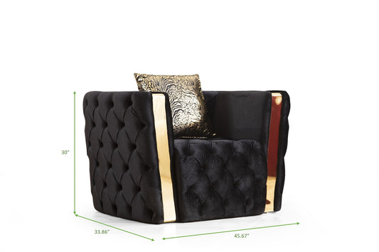 Black tufted velvet armchair with gold trim and animal print pillow