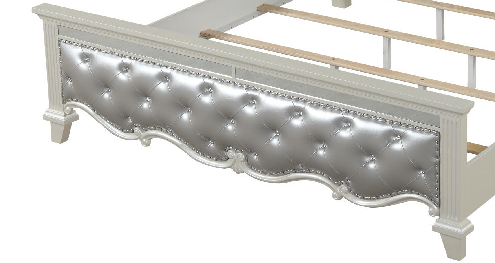 Silver tufted faux leather headboard with crystal accents on a white bed frame