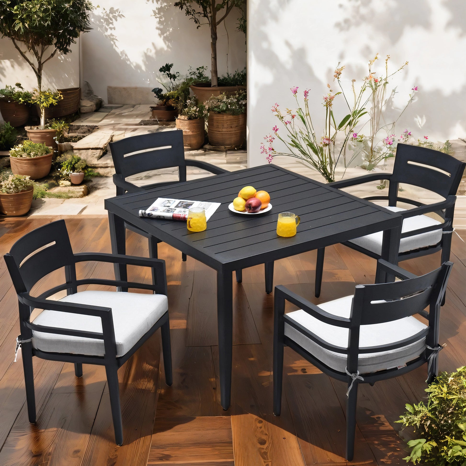 Dark gray aluminum patio dining set with white cushions perfect for outdoor gatherings
