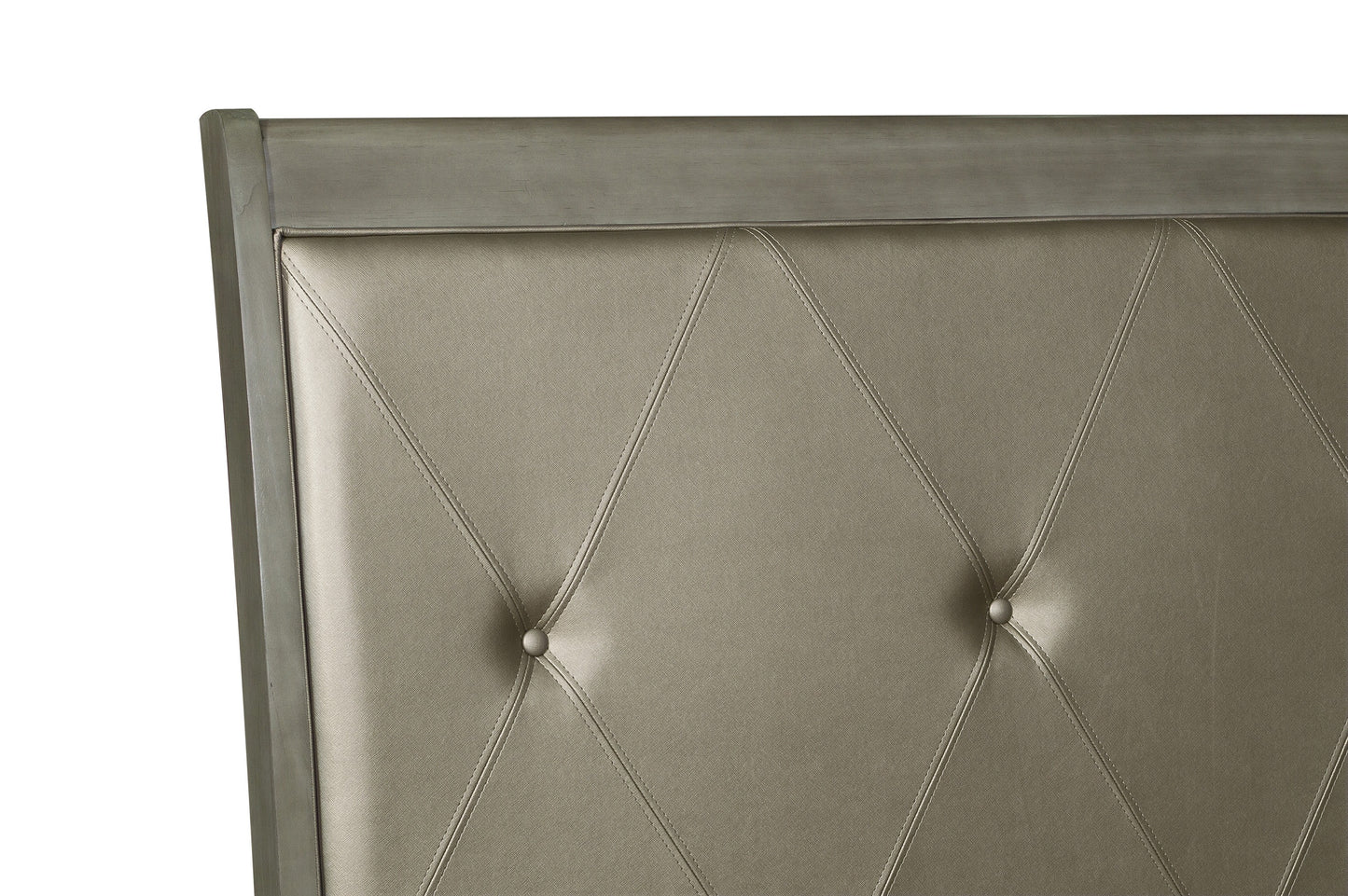 Closeup of tufted champagne faux leather headboard with diamond stitching