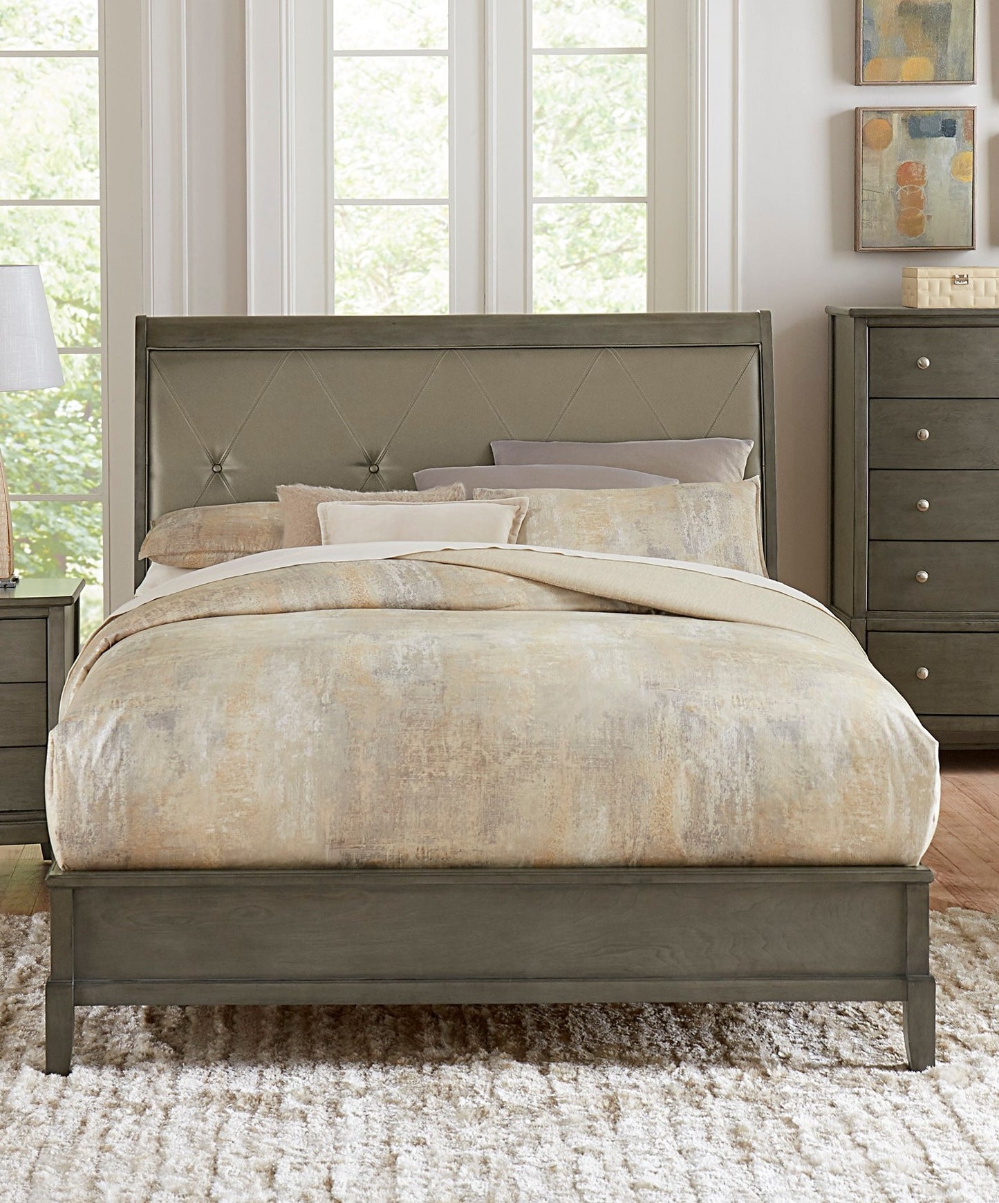 Gray upholstered diamondtufted headboard bed frame with neutral patterned comforter