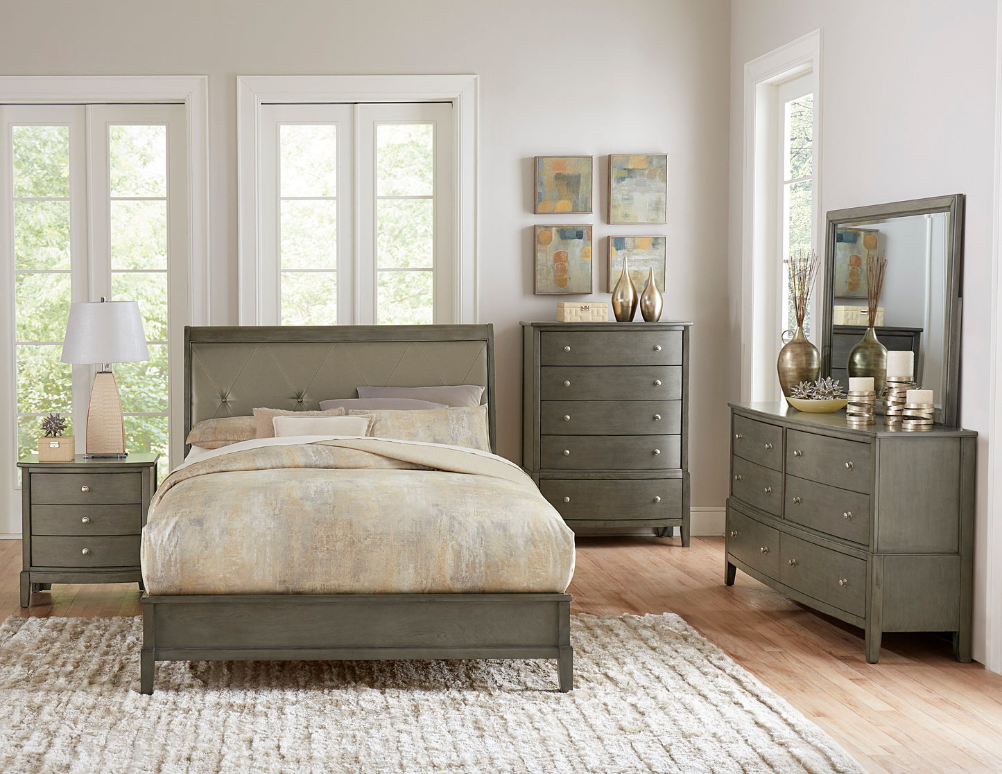 Gray upholstered king bed with tufted headboard and patterned bedding