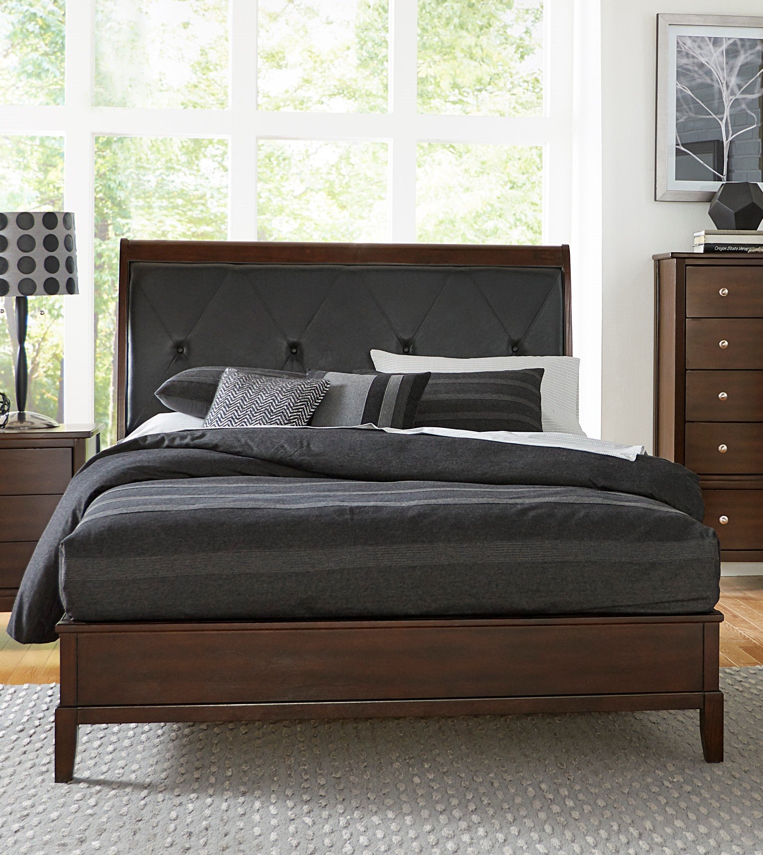 Dark wood platform bed with tufted charcoal grey headboard