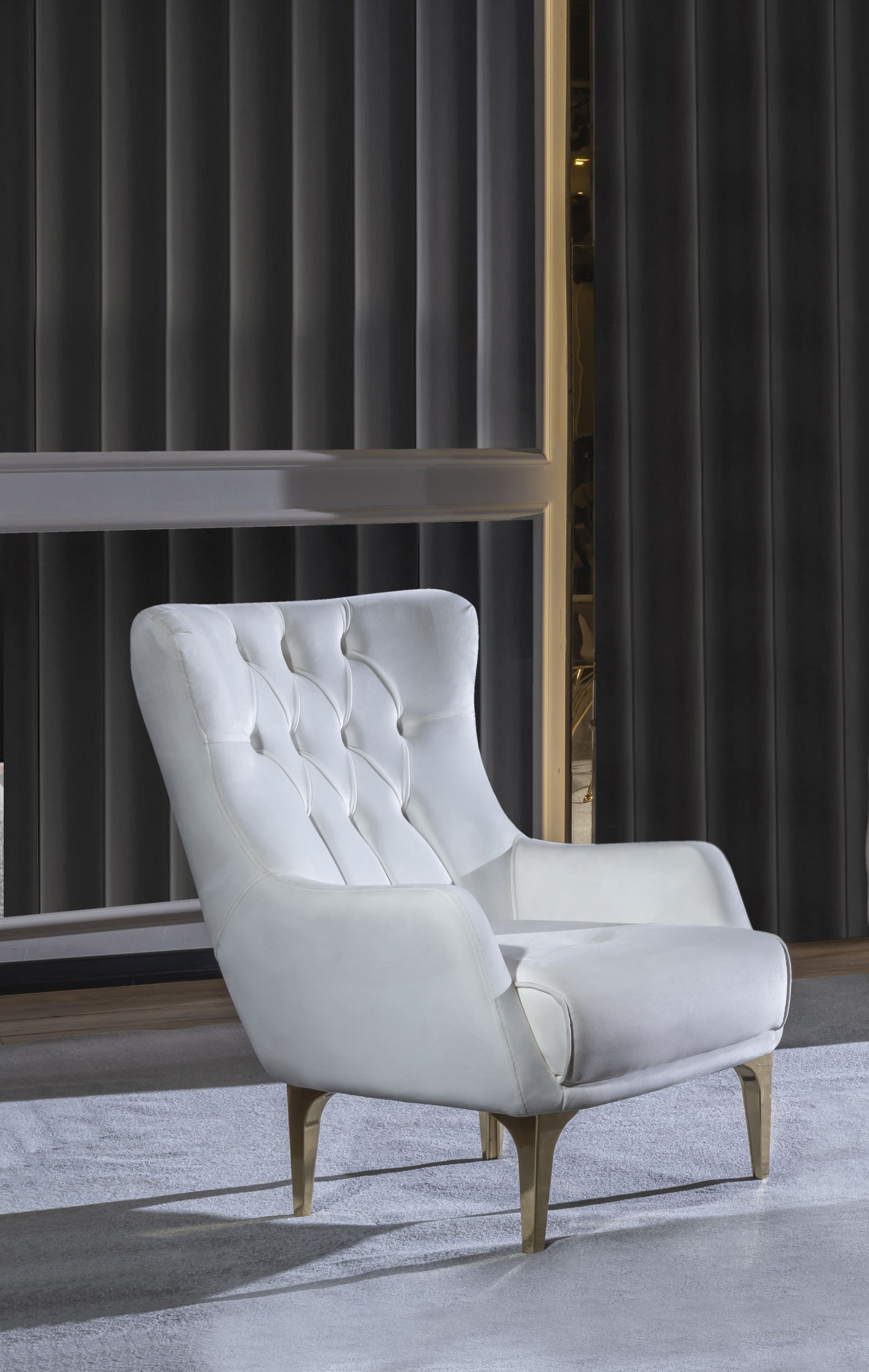 Tufted white leather accent chair with gold tapered legs and a high back