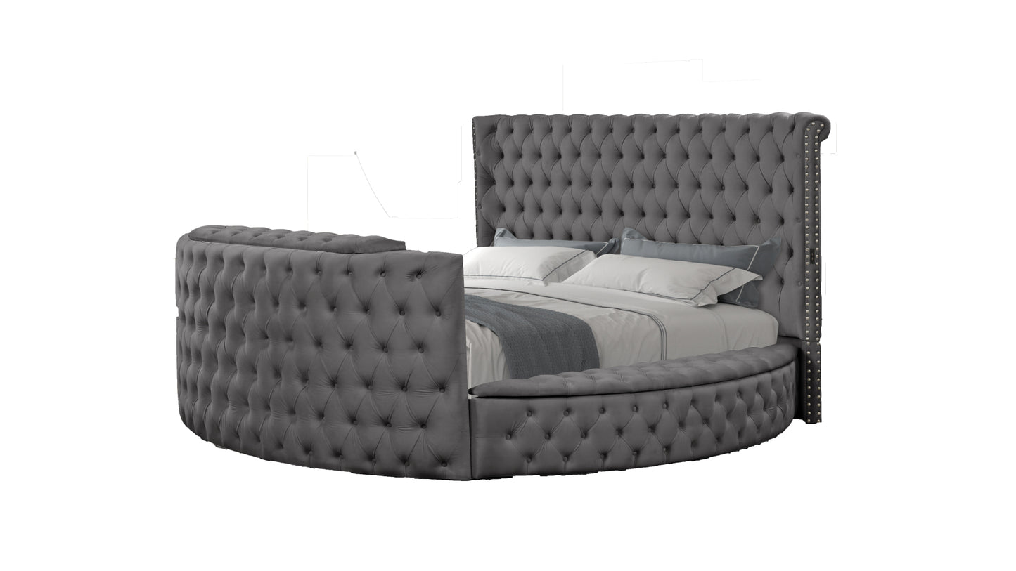 Tufted grey velvet circular bed with nailhead trim and builtin storage ottoman
