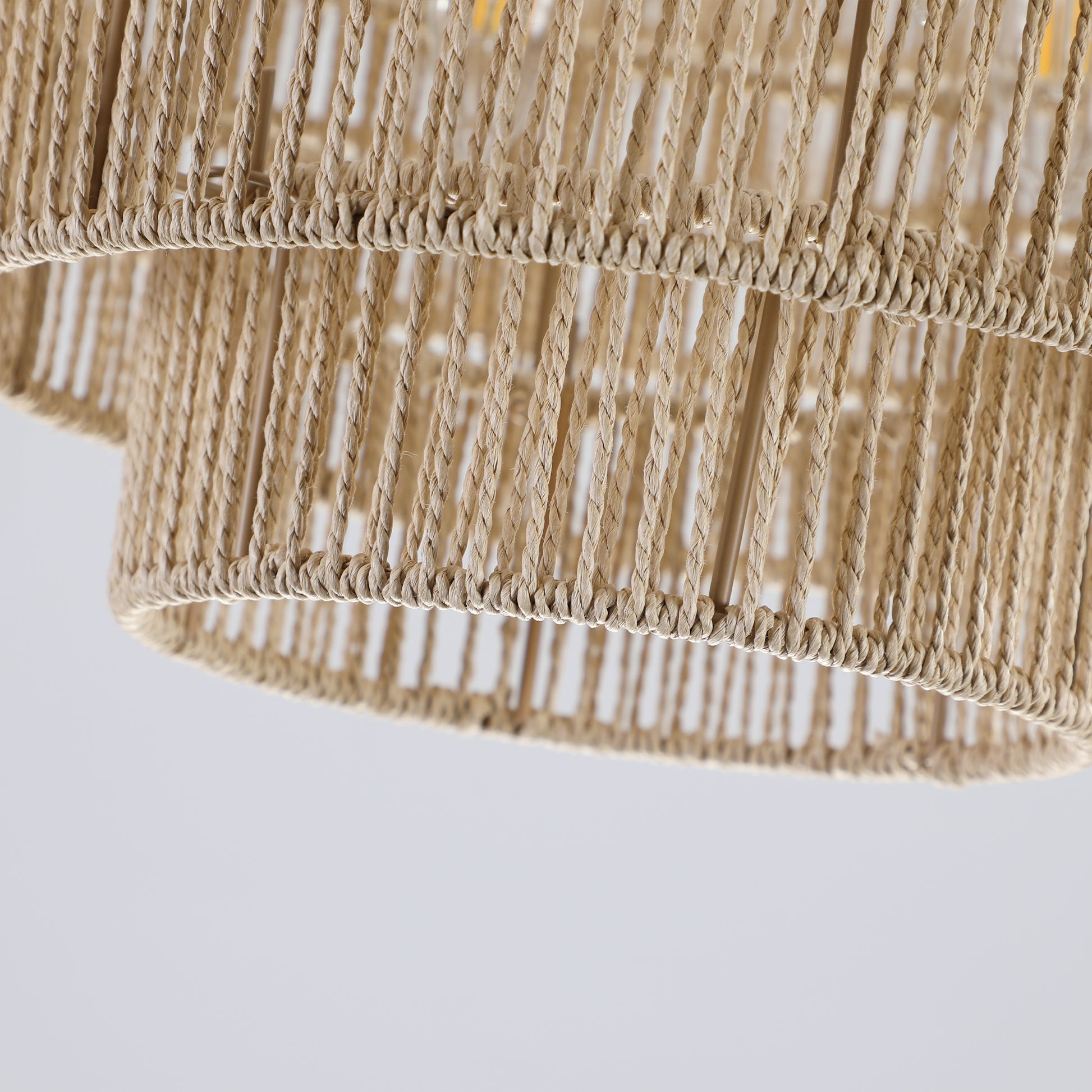 Woven jute pendant light shade with intricate rope detailing and natural beige color