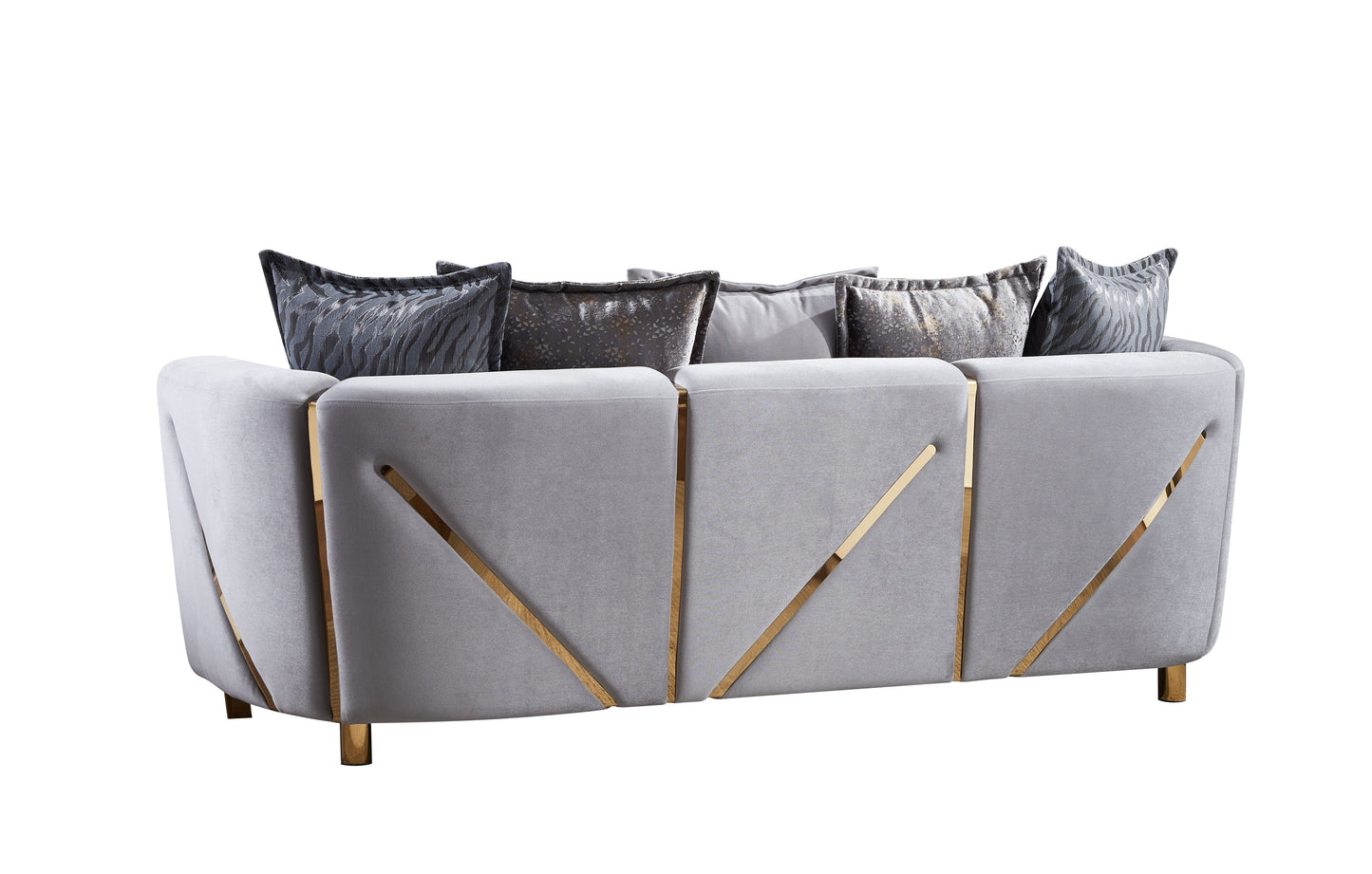 Grey velvet sofa with gold accents and decorative pillows