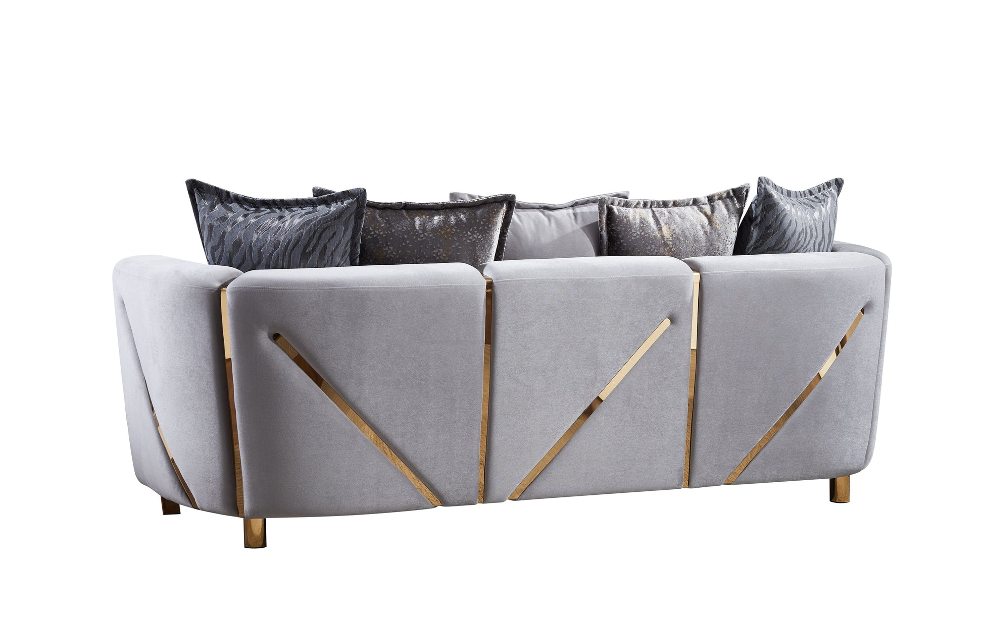 Grey velvet sofa with gold accents and decorative pillows