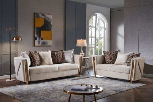 Cream velvet sofa with gold accents and animal print pillows
