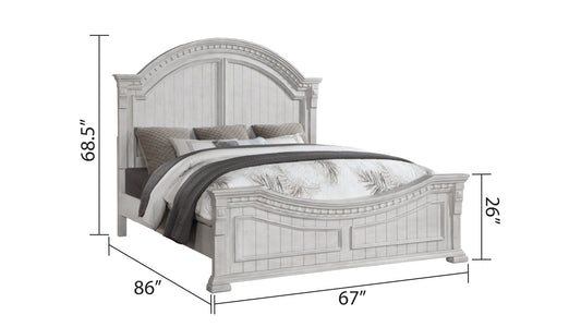 Distressed white wooden bed frame with carved details and arched headboard