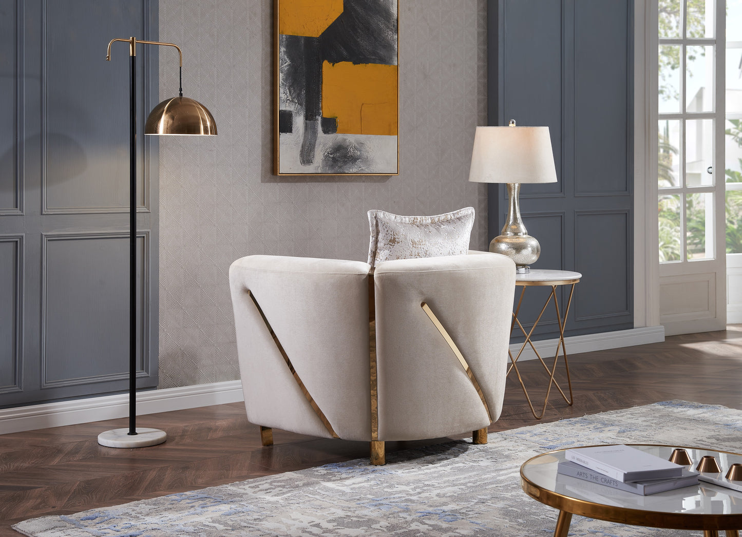 Modern beige velvet accent chair with gold trim and curved back