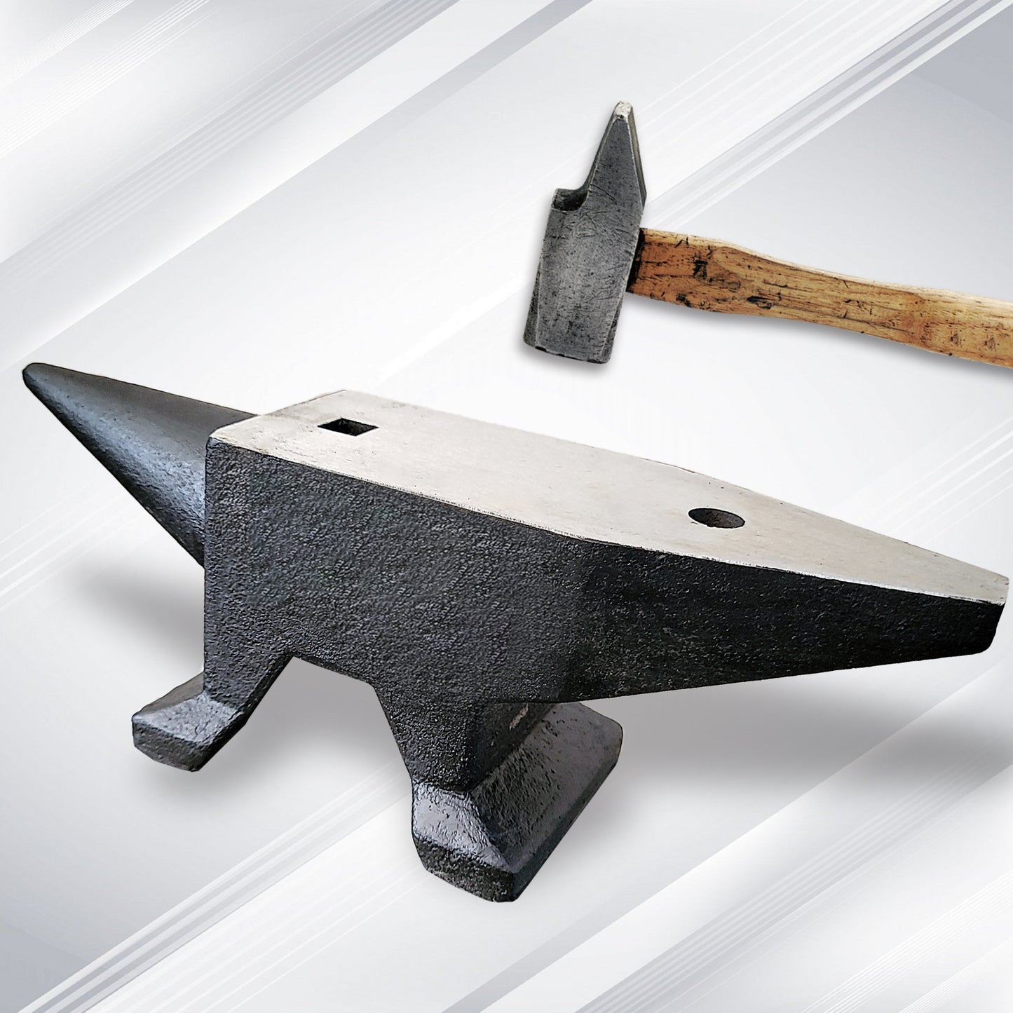 Heavyduty cast iron anvil with a woodenhandled blacksmith hammer ready for forging