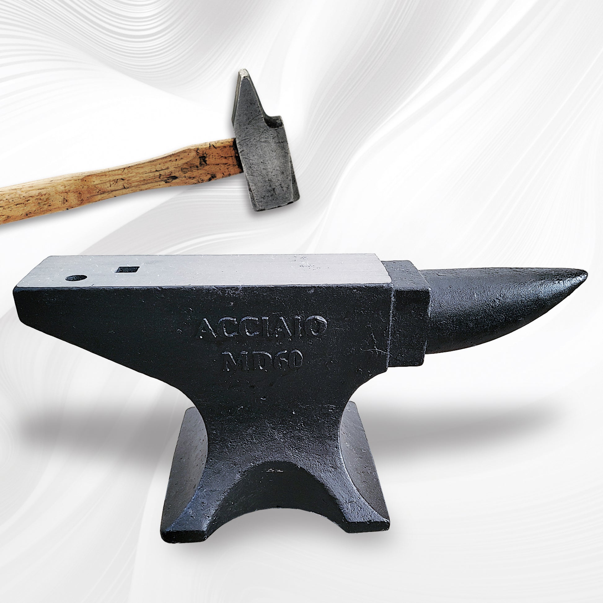 Blacksmith anvil with steel face and wooden mallet ready for use