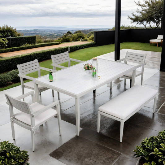 White aluminum patio dining set with slatted chairs and bench