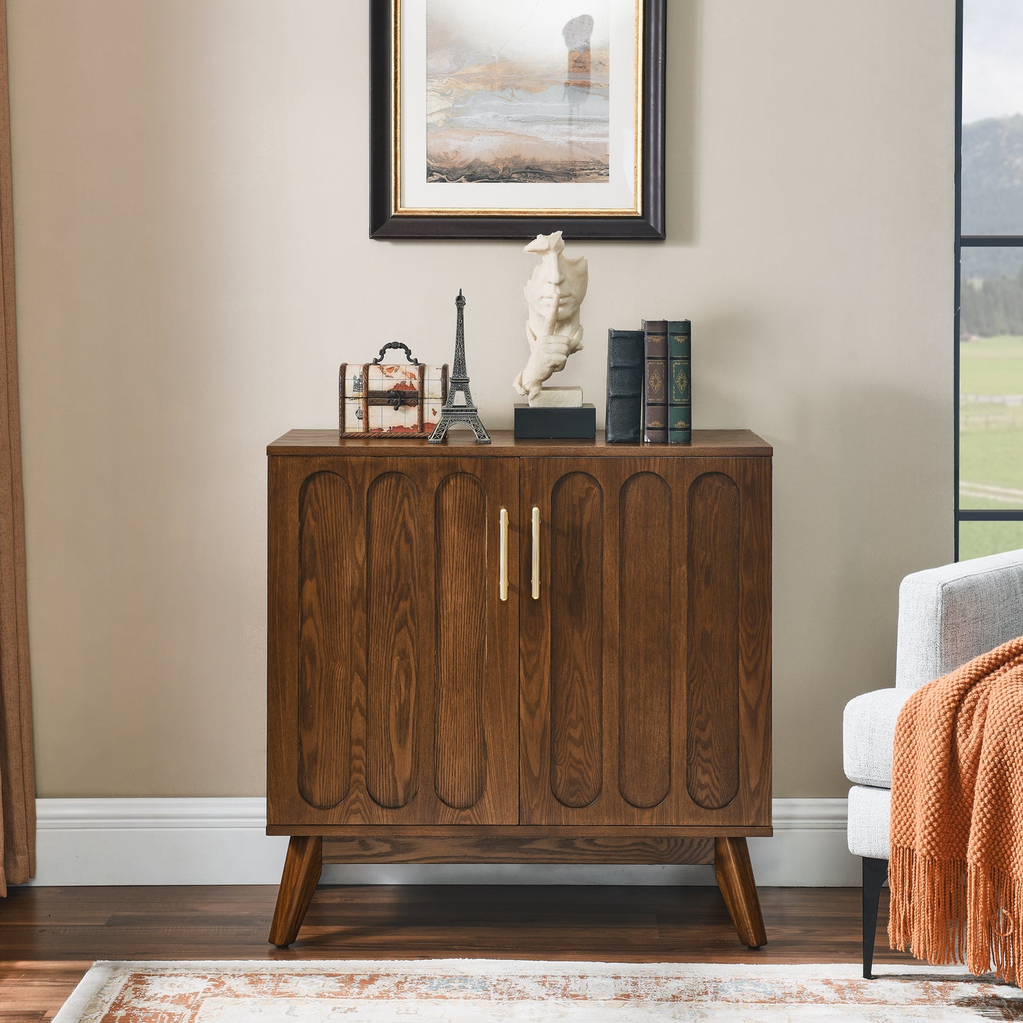 Midcentury modern wood accent cabinet with fluted doors and gold handles