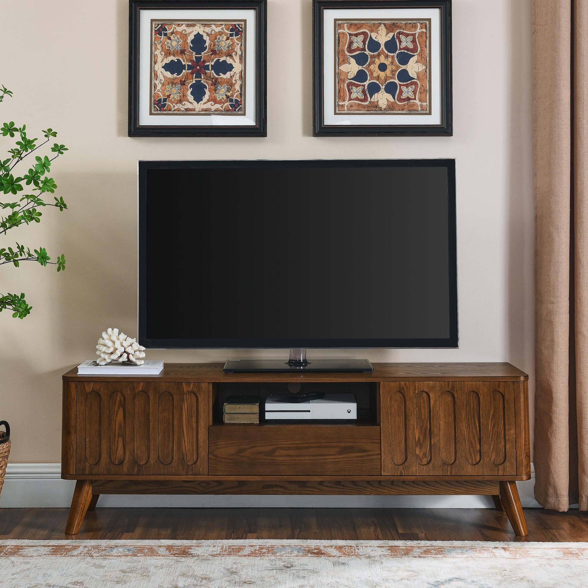 Midcentury modern brown wood TV stand with fluted details and tapered legs