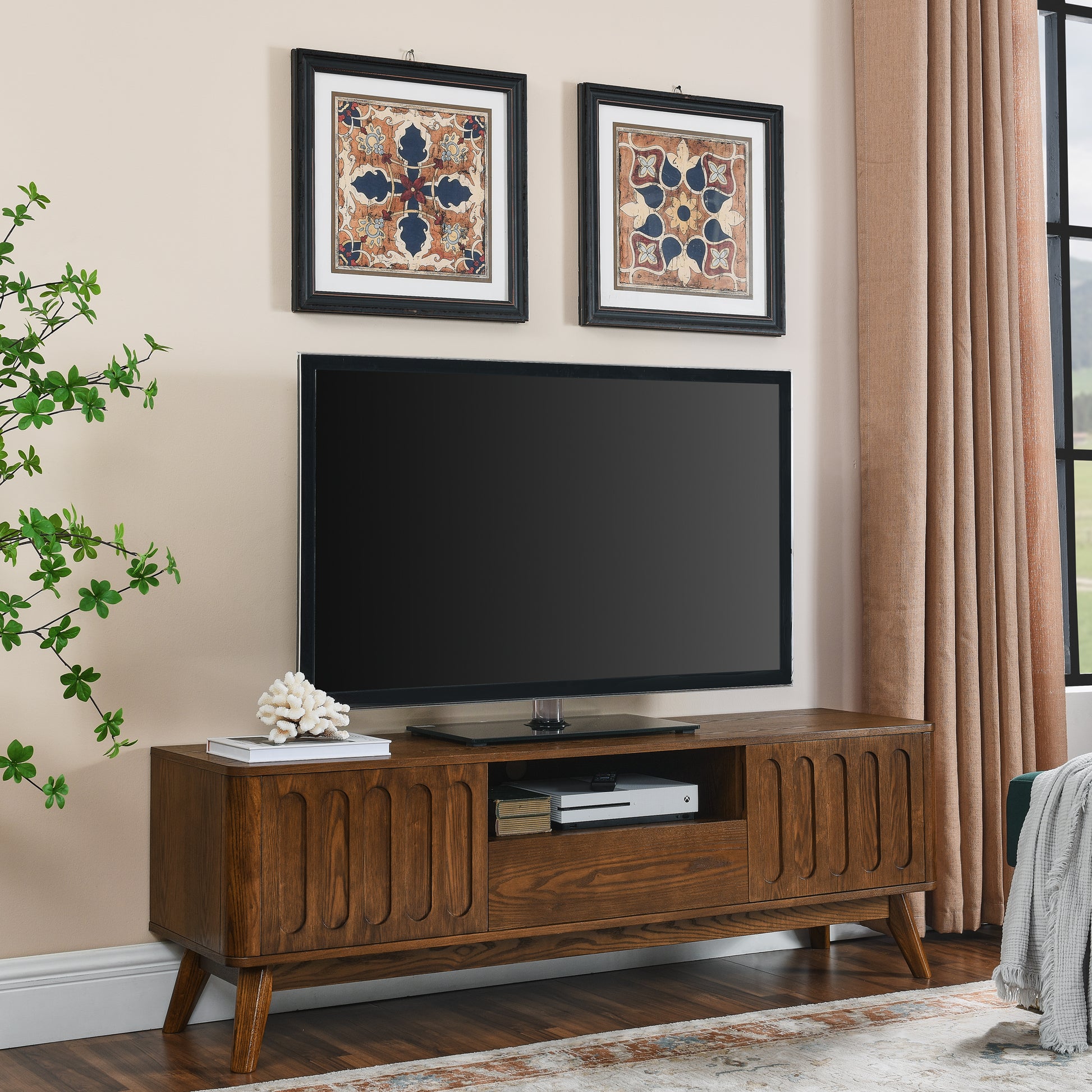 Midcentury modern brown wood TV stand with fluted doors and tapered legs