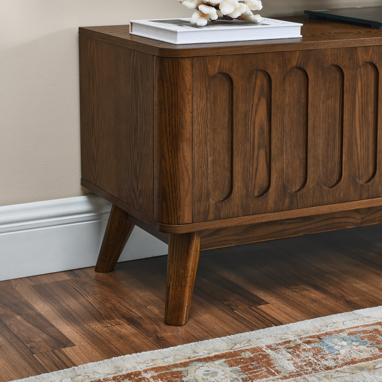 Midcentury modern media console with rich walnut finish and carved vertical detailing