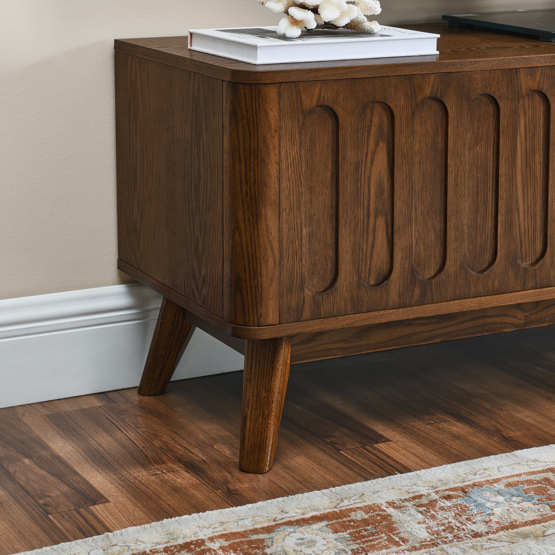 Midcentury modern media console with rich walnut finish and carved vertical detailing