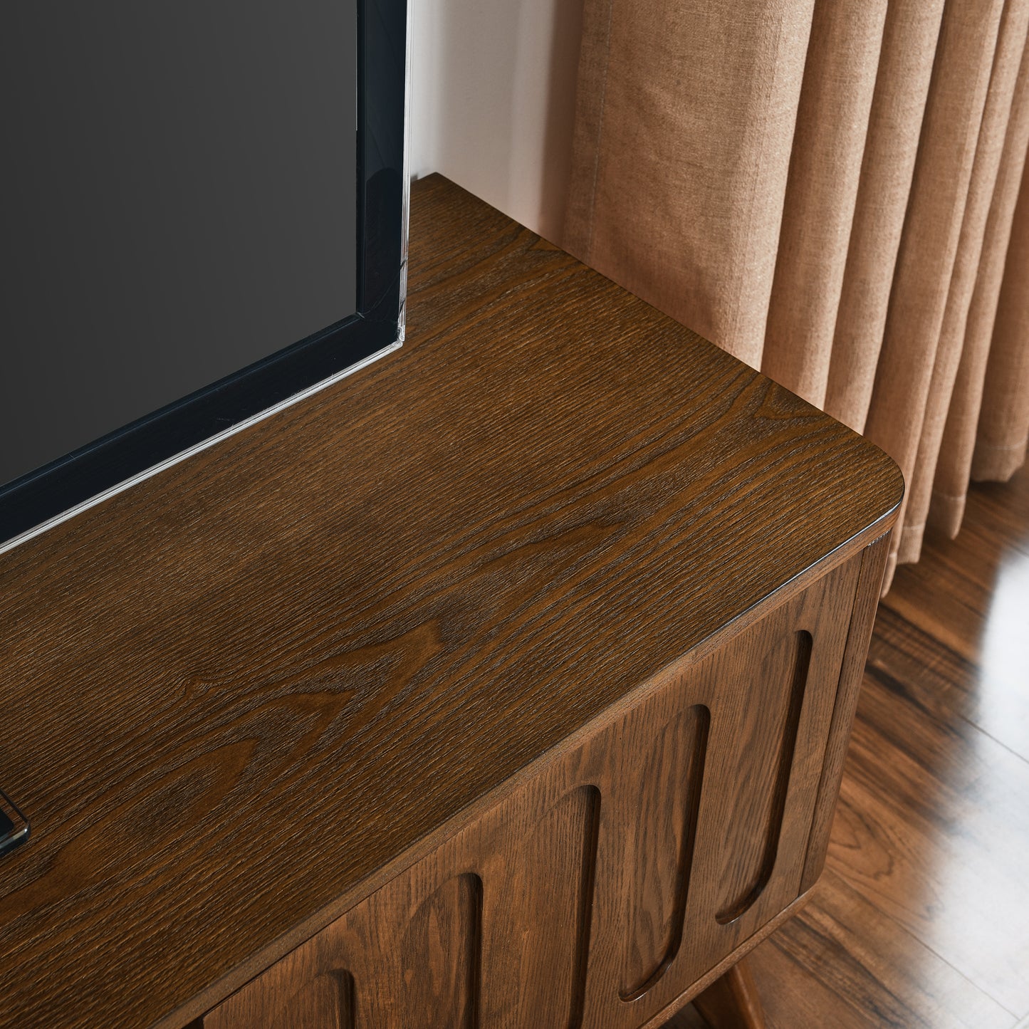 Modern walnut TV stand with grooved drawer fronts and clean lines