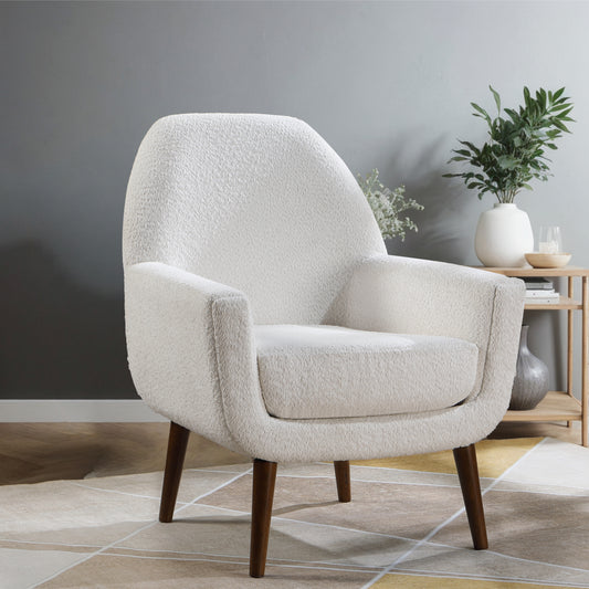 Plush cream boucl armchair with tapered dark wood legs perfect for a cozy living room accent chair